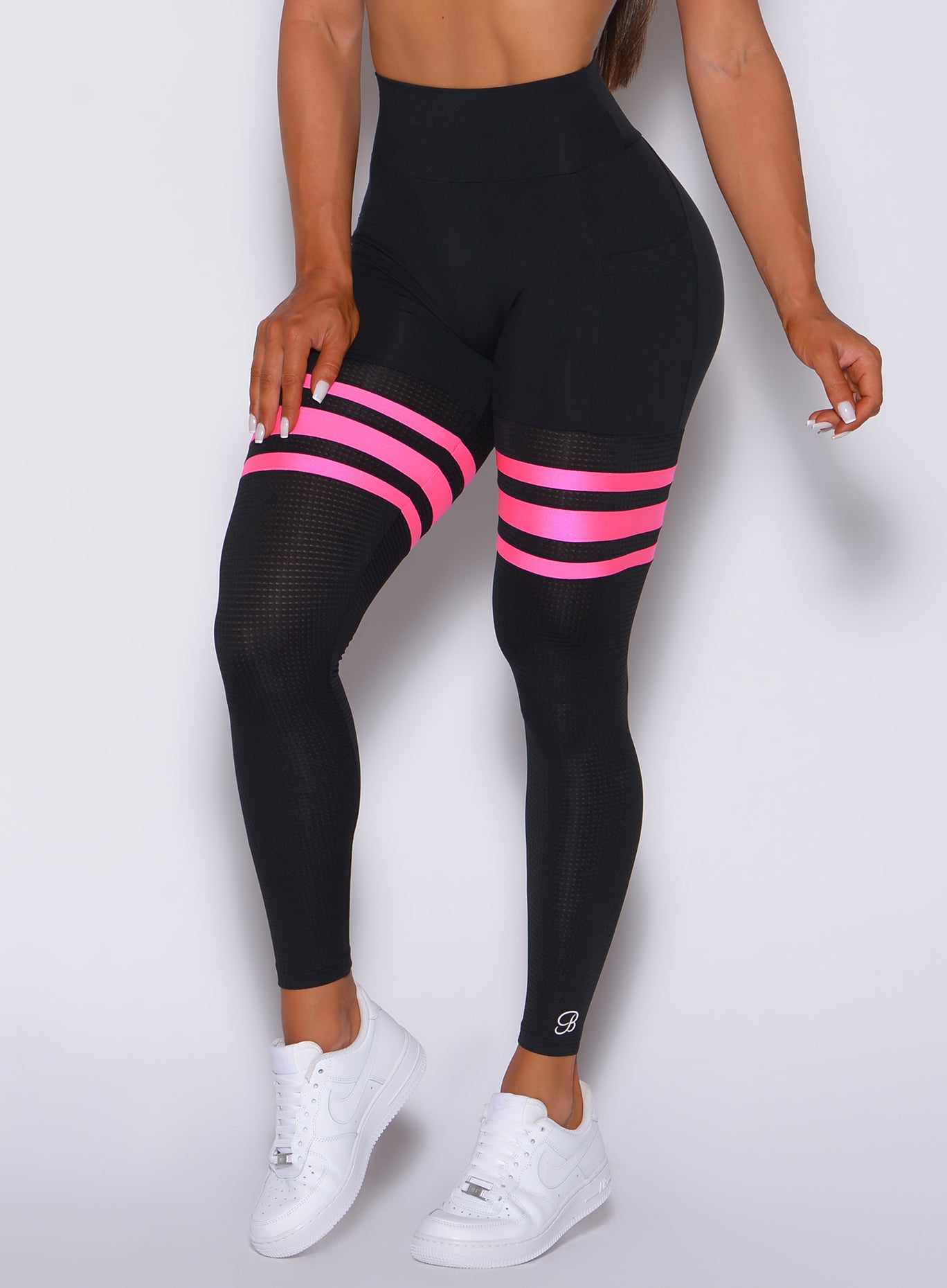 Zoomed in front profile view of our scrunch thigh high with neon pink stripes on the thighs 