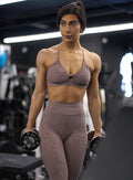 front profile view of a model wearing our curves leggings in london fog color along with the matching sports bra