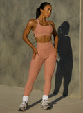 front profile view of a model wearing our Curves leggings in Nude Sand color, paired with the matching bra.