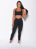 Front profile view of a model wearing our toggle leggings and a matching sports bra 