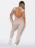 back profile picture of a model in our open back tee bodysuit in nude color