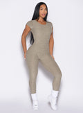 front profile view of a model with both hands on her thighs wearing the Open Back Tee Bodysuit in Toasted Sugar color