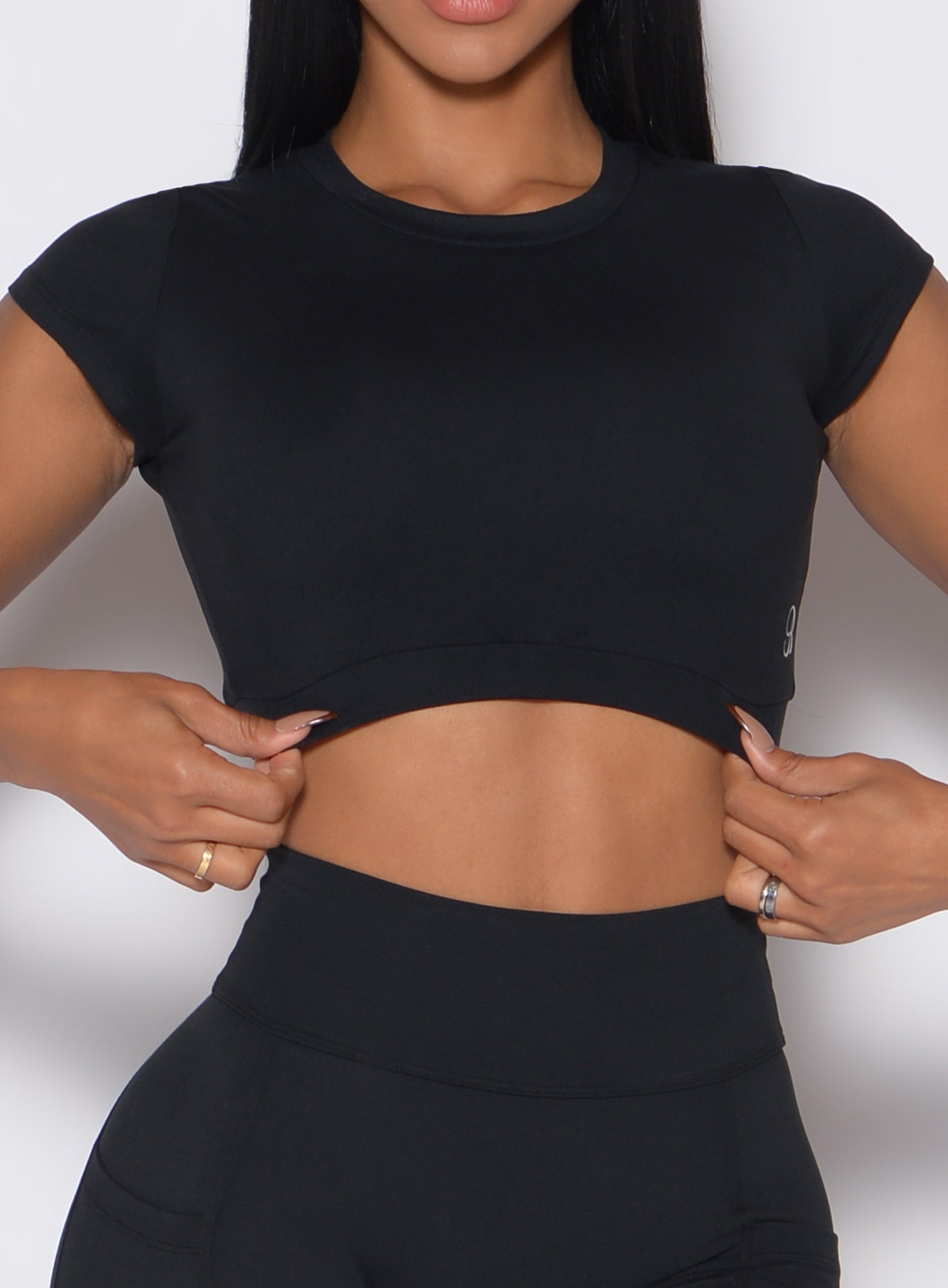 Sculpting black Open Back Tee; breathable second-skin fabric and a cropped fit for high-intensity training.