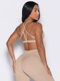 back right side profile view of a model wearing the Passion Sports Bra in glacial beige color
