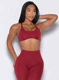 front profile view of a model looking to the left wearing the Passion Sports Bra in red velvet color