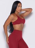 front right side profile view of a model wearing the Passion Sports Bra in red velvet color