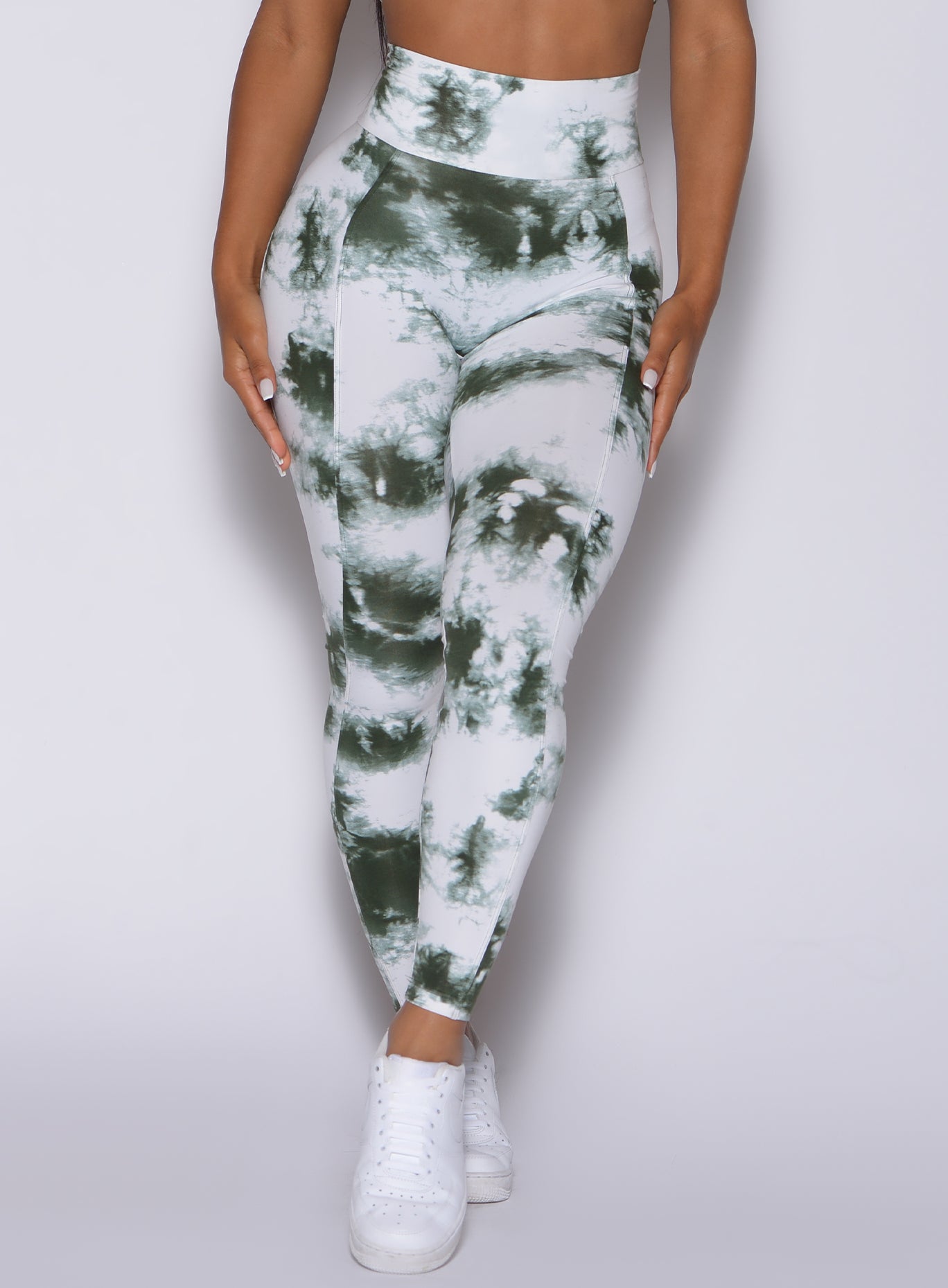 Zoomed in front view of our tie dye peach booty leggings in white green 