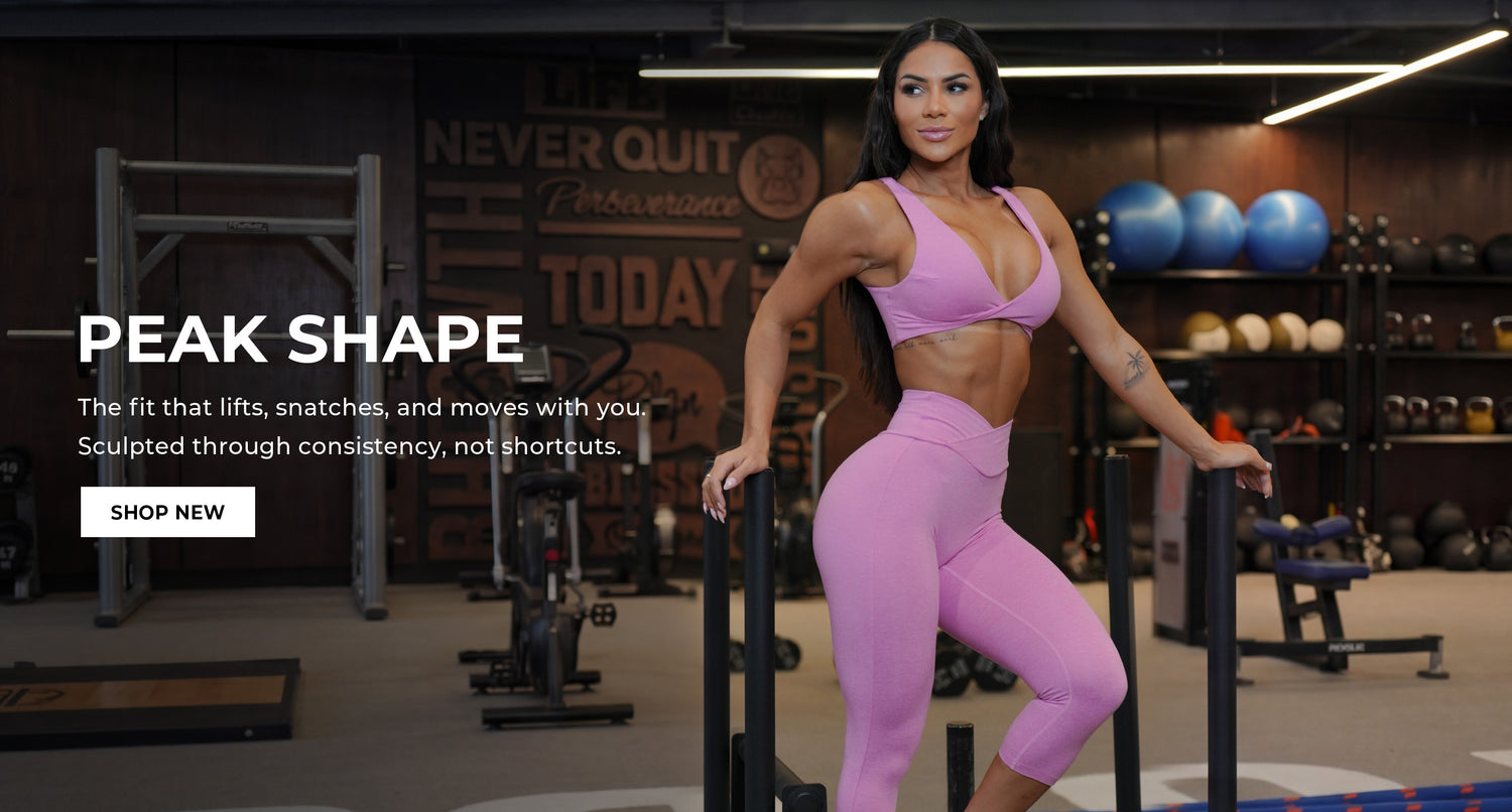 Model wearing pink matching active bra and capri leggings standing in a gym setting. Text overlay says "PEAK SHAPE The fit that lifts, snatches, and moves with you. Sculpted through consistency, not shortcuts." Call to action: SHOP NEW