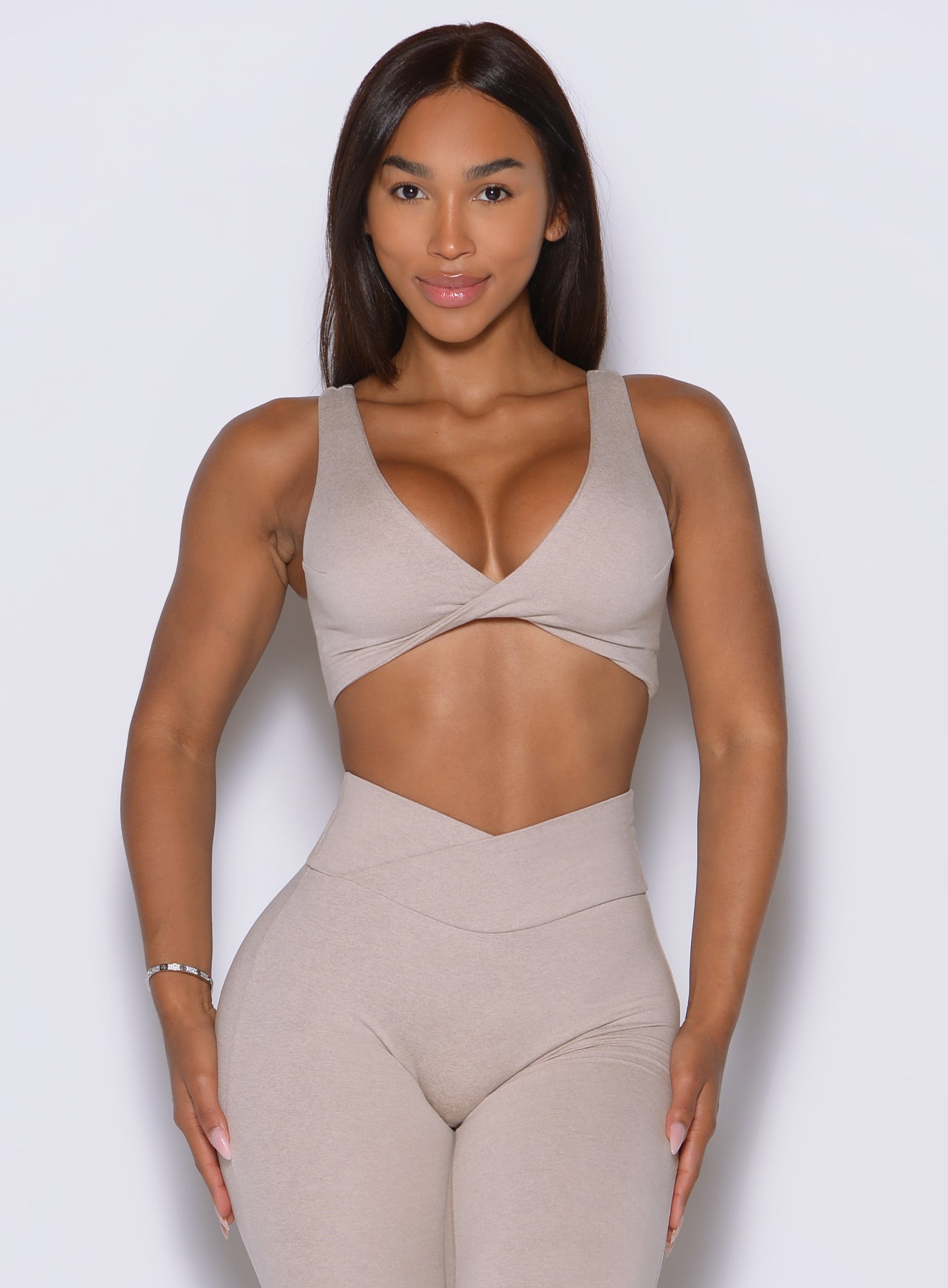 Front view in Taupe pairs twist-front lift with sculpting support and a refined sleek finish.