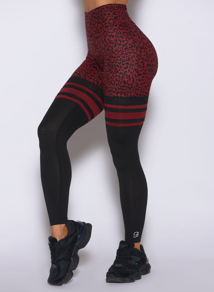 Close-up of Bombshell Perform Thigh-Highs Leggings highlighting cheetah print and mesh panels
