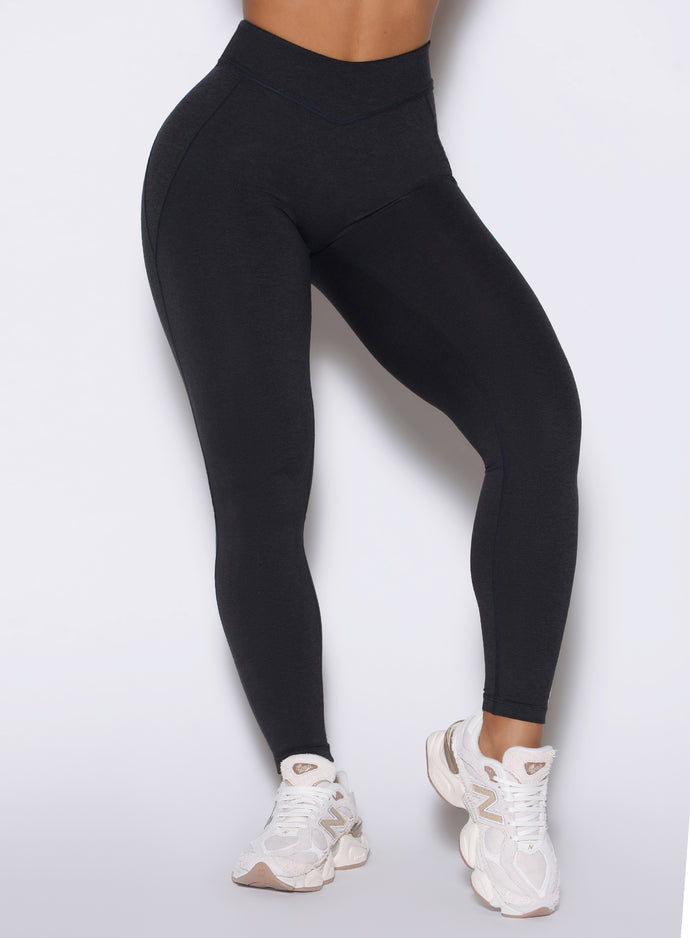 Detailed close up frontal shot of the model wearing our Physique leggings in Heathered Black color.
