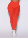 Detailed close up frontal shot of the model wearing our Physique leggings in Inferno color.