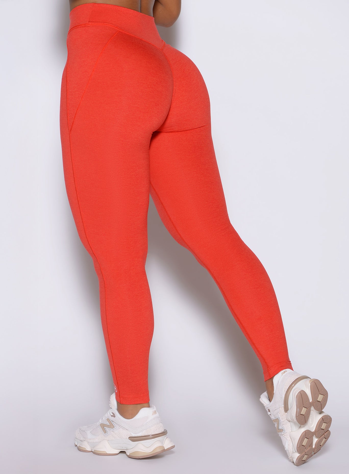 Detailed close-up back shot of the model wearing our Physique leggings in Inferno color.