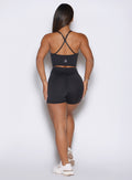 Back view of heathered black Physique Shorts featuring an internal scrunch and sculpting seams.