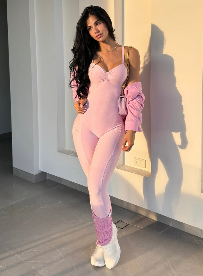 model in outdoors wearing the luxe leg warmers-short in pink paloma color paired with the matching flawless form bodysuit