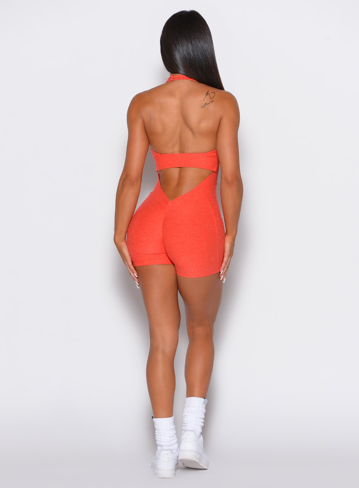 Apricot Backless Pocket Bodysuit Short with a deep V-cut and sculpting scrunch butt fit.