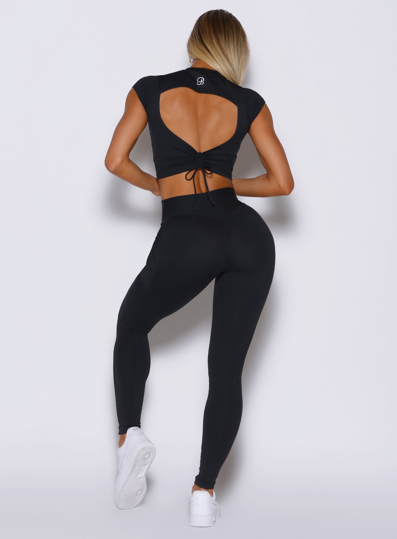 back profile view of a model wearing the PocketBoost Leggings in Black color