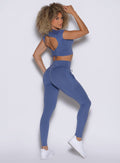 side right profile view of a model wearing the PocketBoost Leggings in Blue Slate color