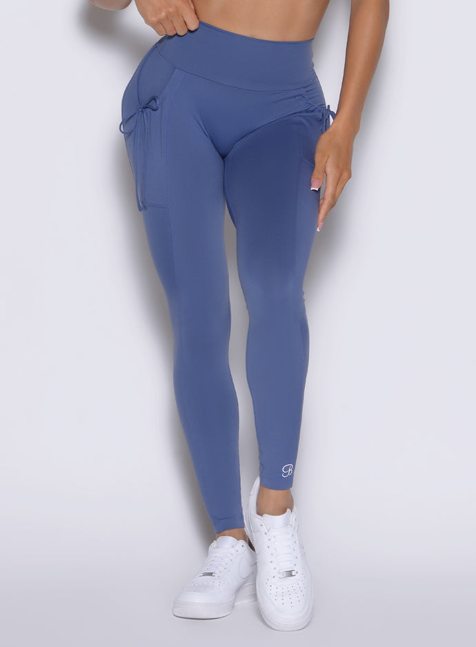 close up view of a model wearing the PocketBoost Leggings in Blue Slate color