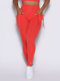 close up front view of a model wearing the PocketBoost Leggings in Command red color