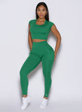 front profile view of a model wearing the PocketBoost Leggings in Field Green color