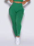 close up front view of a model wearing the PocketBoost Leggings in Field Green color