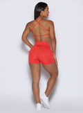 close up back profile view of a model wearing the PocketBoost Shorts in command red color