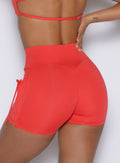 close up zoomed in back profile view of a model wearing the PocketBoost Shorts in command red color