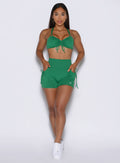 front profile view of a model wearing the PocketBoost Shorts in Field Green color