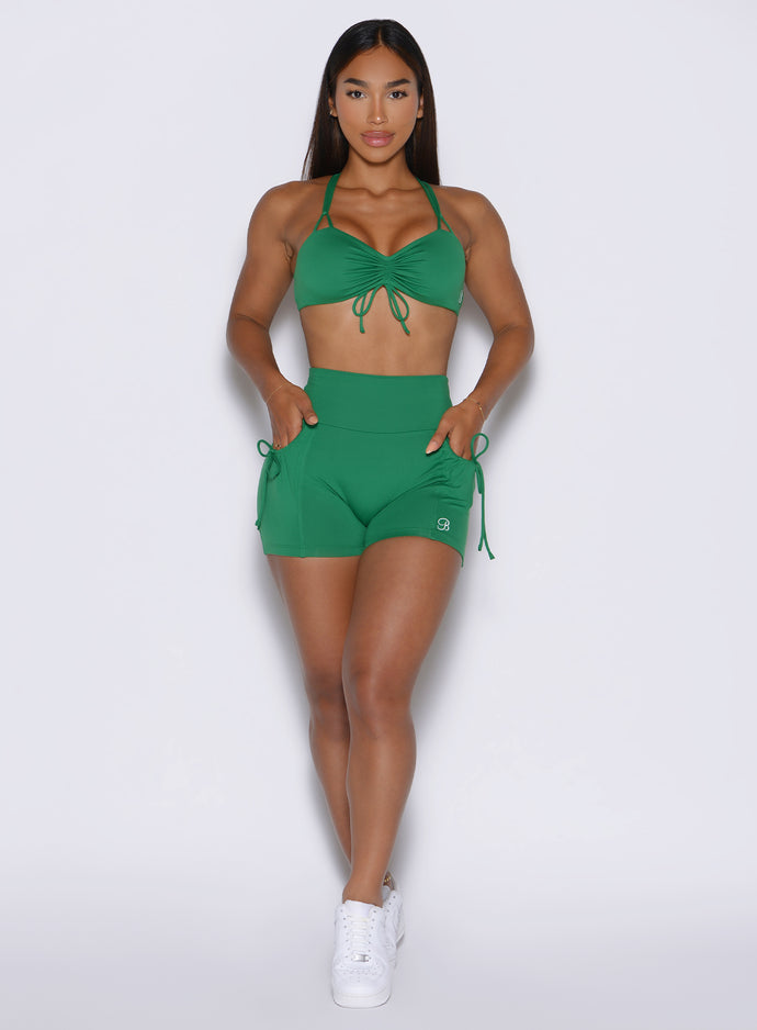 front profile view of a model wearing the PocketBoost Shorts in Field Green color