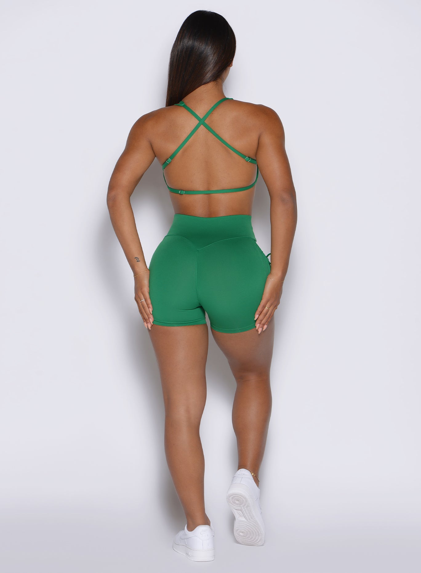 Back view of Field Green PocketBoost Shorts featuring a sculpting high-waisted fit and side pockets.