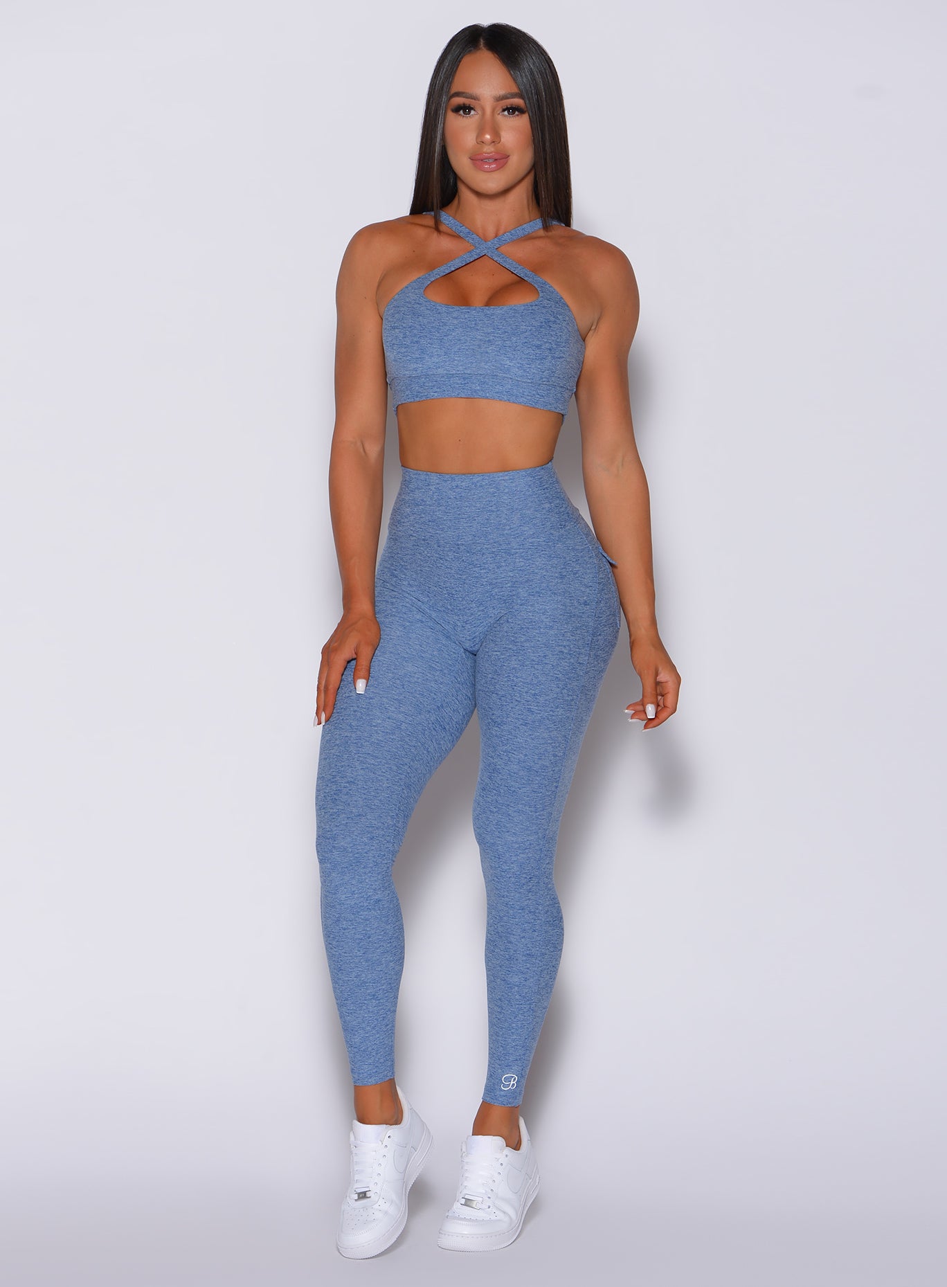 Front profile view of a model in our Pocket Pop Leggings in sky blue color and a matching sports bra
