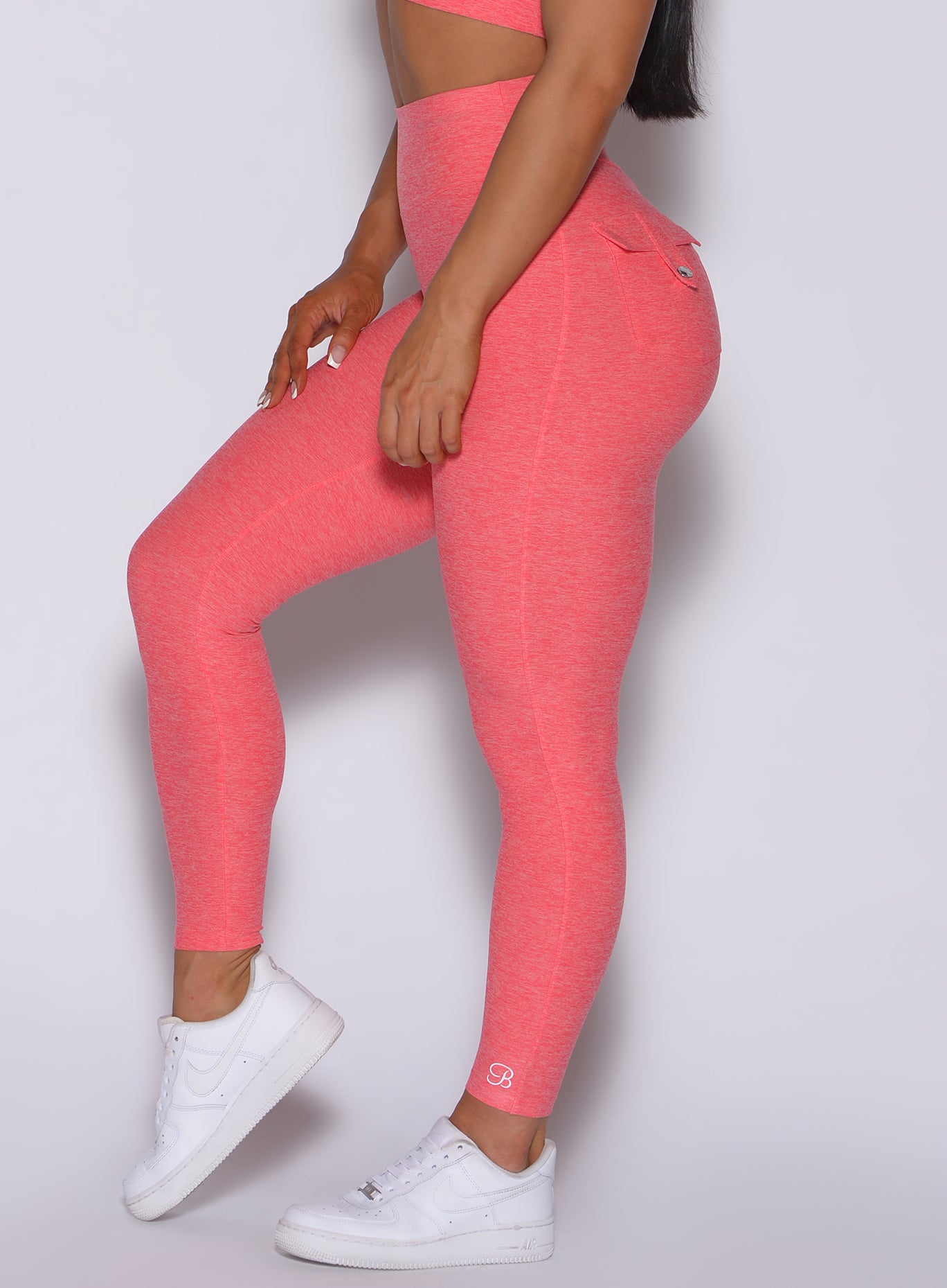 zoomed in left side view of our Pocket Pop Leggings in papaya color 