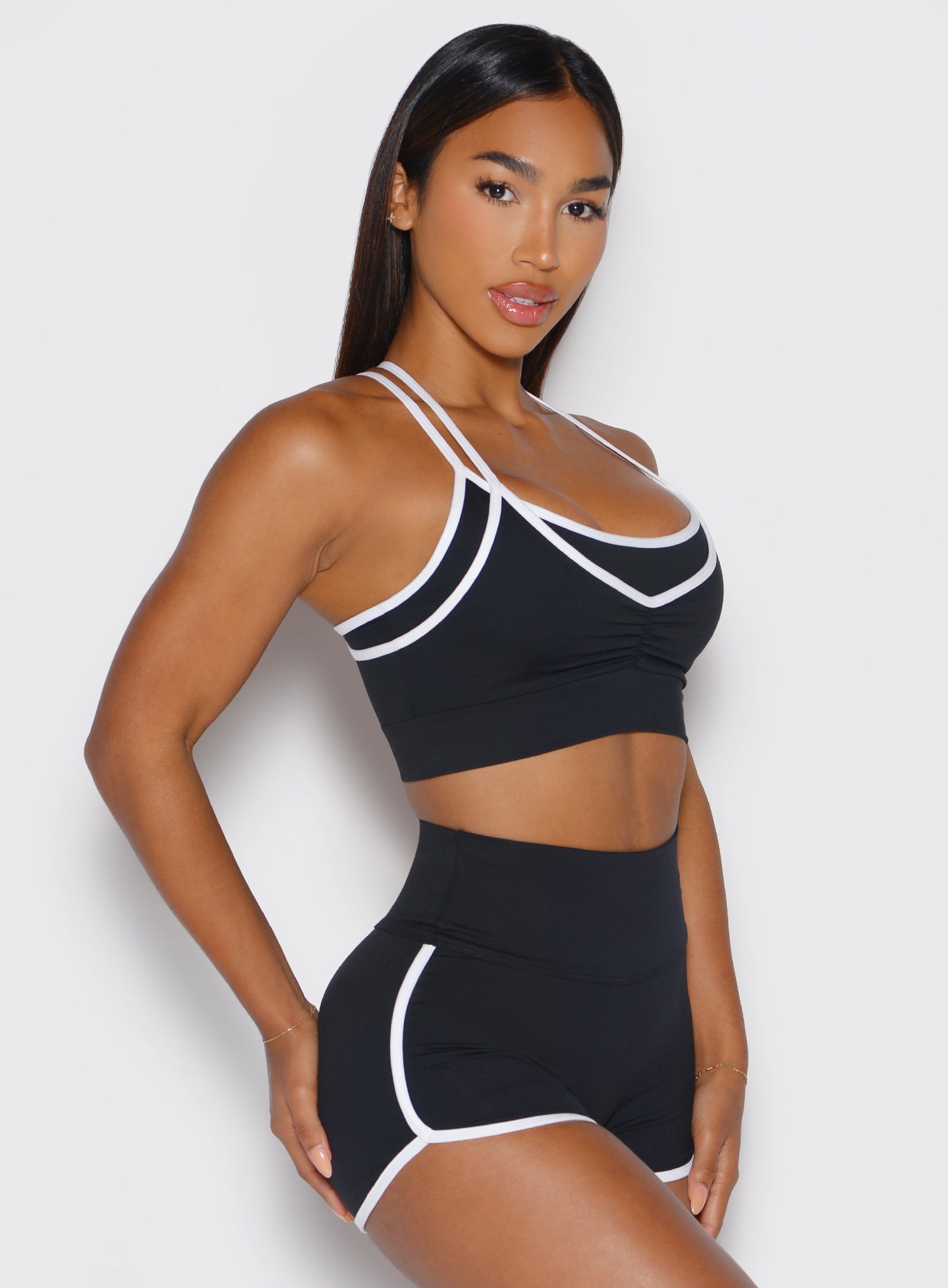 Black Power Line Bra featuring a front scrunch detail and contrast binding in a side profile view.