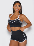 front view of a model looking to the left side wearing the power line bra in black color