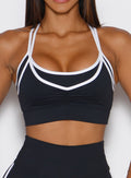 close up front view of a model wearing the Power Line Bra in black color