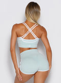 back profile view of a model wearing  the Power Line Bra in cool arctic color