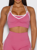 close up front view of a model wearing the Power Line Bra in empowered pink color