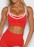 close up front view of a model wearing the Power Line Bra in power red color