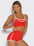 front profile view of a model wearing the Power Line Bra in power red color