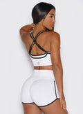 back right side profile view of a model wearing the Power Line Bra in white color