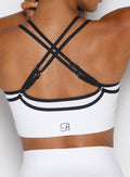 zoomed in back profile view of a model wearing the Power Line Bra in white color