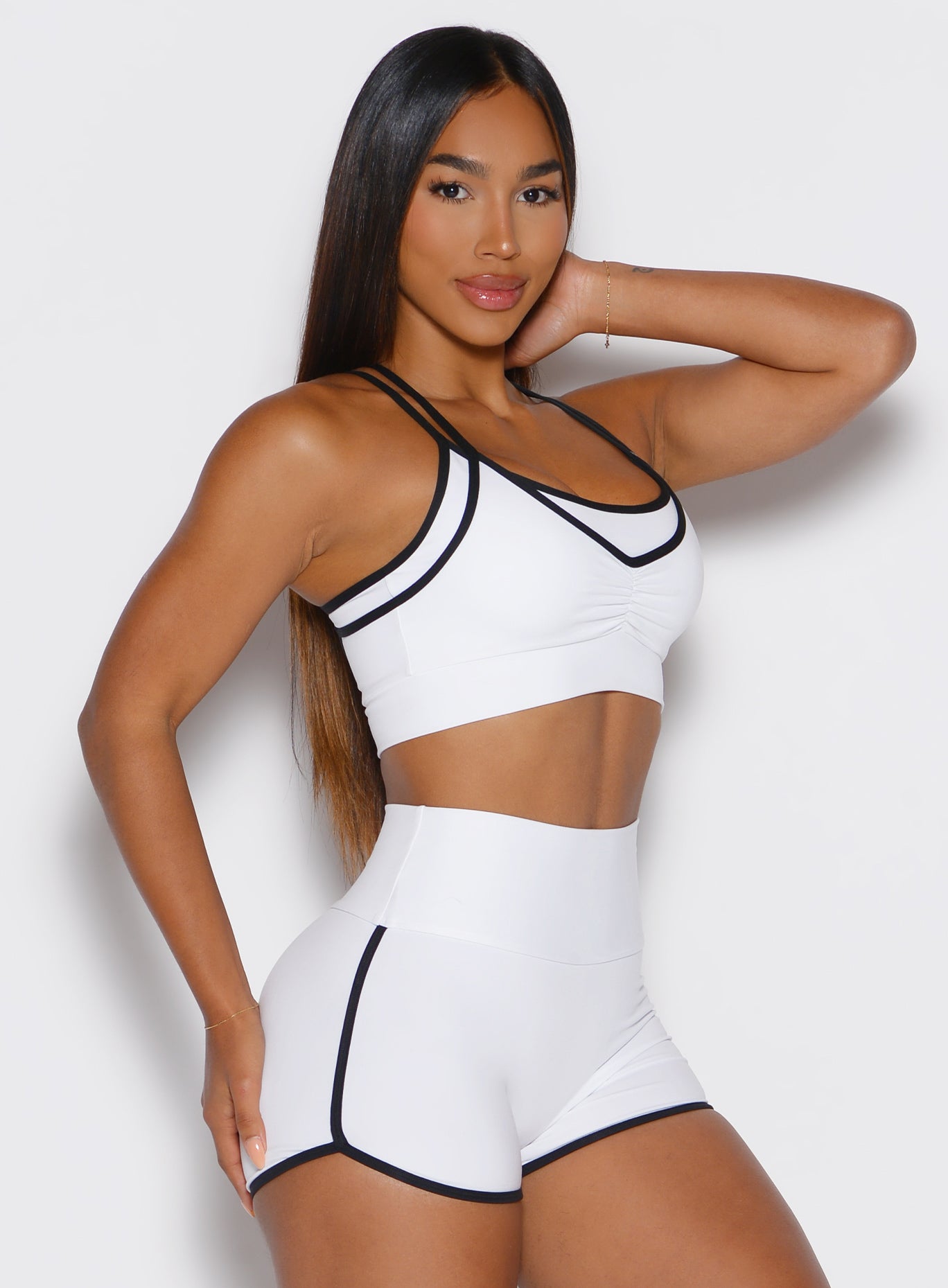 front right side view of a model wearing the Power Line Bra in white color
