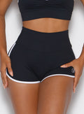 zoomed in front view of a model wearing the Power line shorts in black color