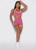 front profile view of a model wearing the Power line shorts in empowered pink color