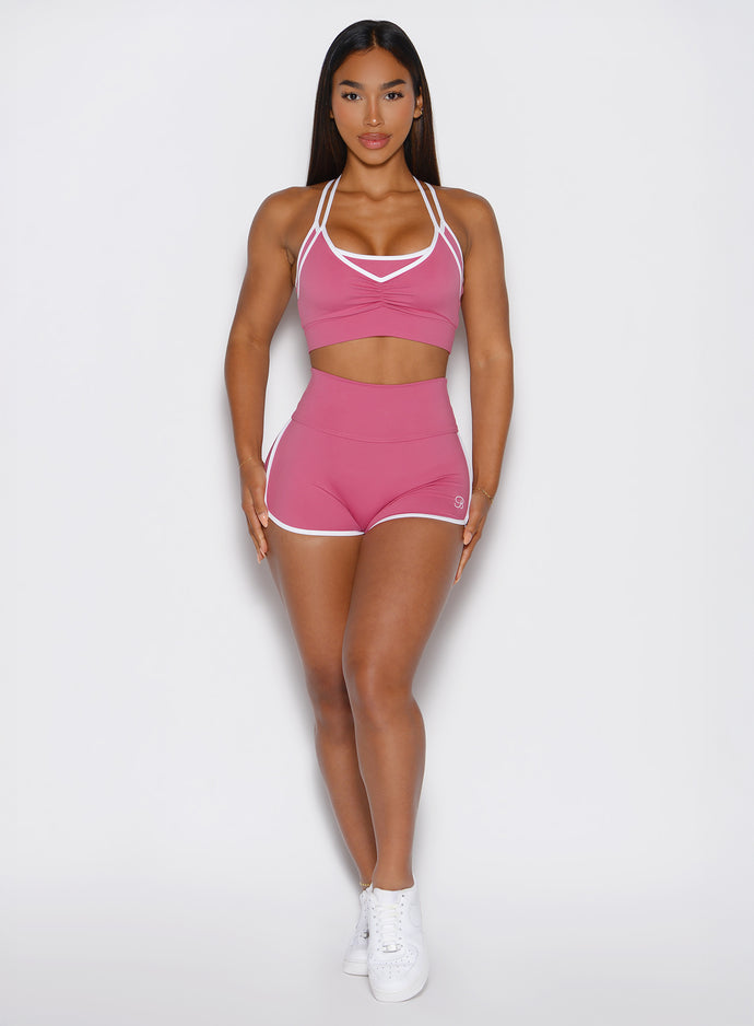 front profile view of a model wearing the Power line shorts in empowered pink color