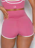 zoomed in back profile view of a model wearing the Power line shorts in empowered pink color