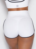zoomed in back profile view of a model wearing the Power line shorts in white color