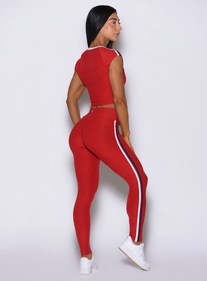 Back corner look at Sunset red Power Play leggings, maximizing curve enhancement and lifting support