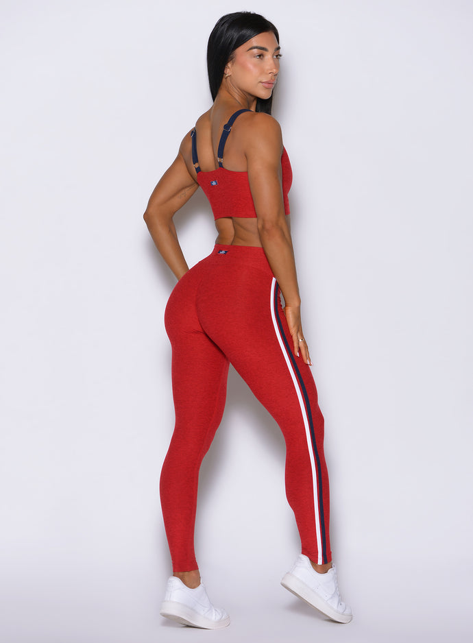Turn-around angled shot of red Power Play leggings, detailing the instant lower-body sculpting